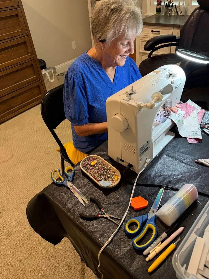 Jeannine Gallacher, the grandmother, sewing bandanas in her home office